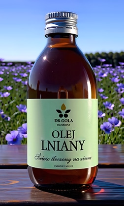 Butelka oleju lnianego i pole lnu w tle