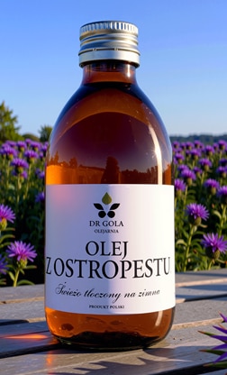 Butelka oleju z ostropestu na tle pola ostropestu